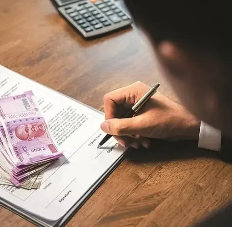 Cheque based private finance in Chennai with business owner signing financial documents
